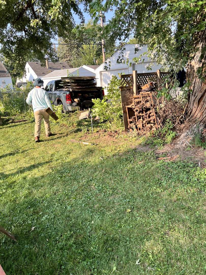 Pickup truck loaded with demolished fence boards